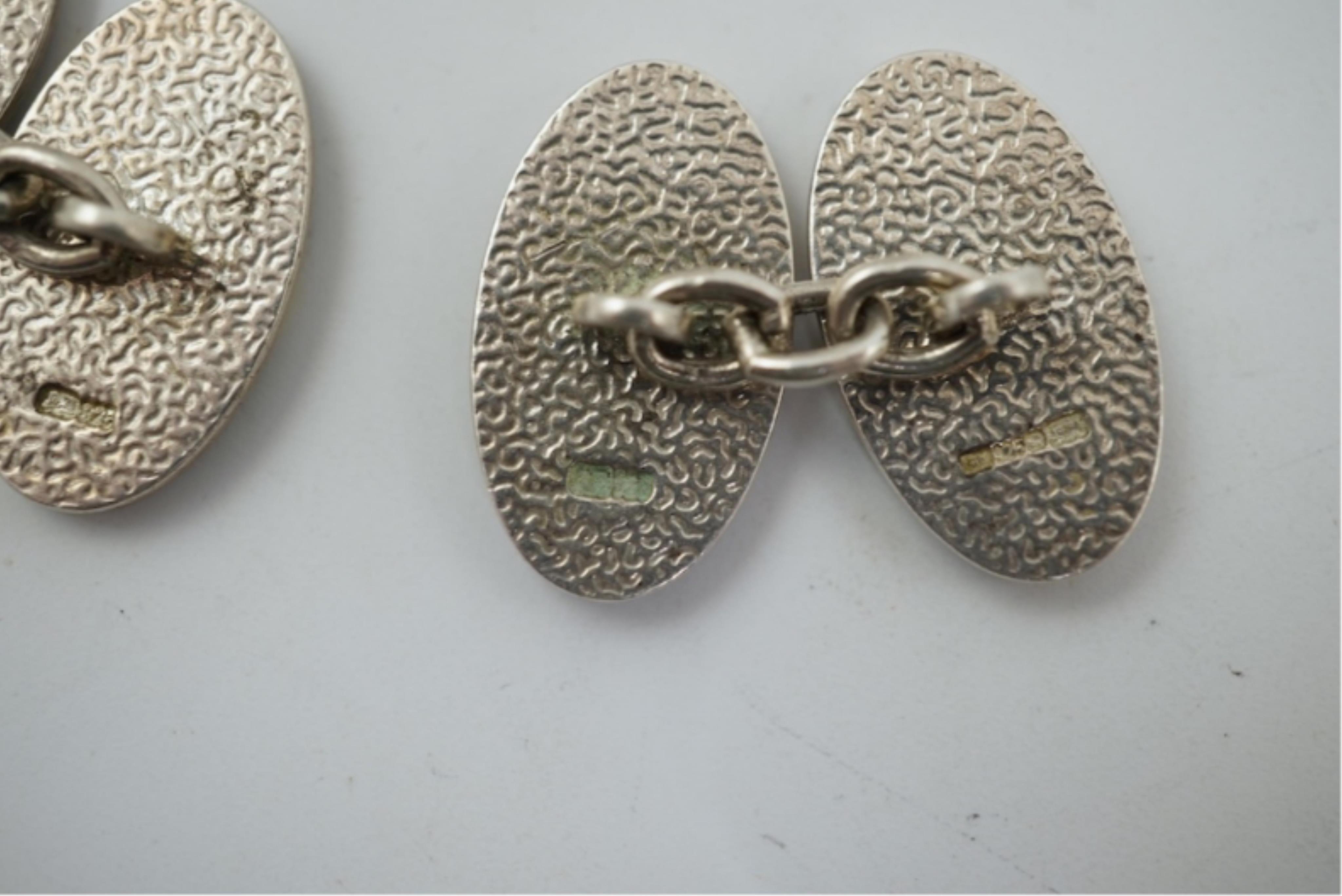 A modern pair of silver and polychrome enamel set oval cufflinks, 18mm.
